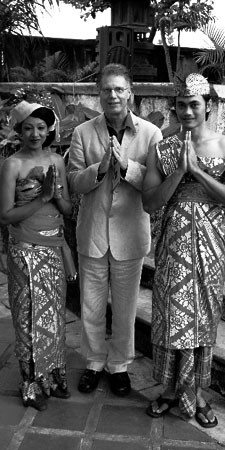 Photo of Robert Morgan in Bali with hands clasps in greeting along with two others